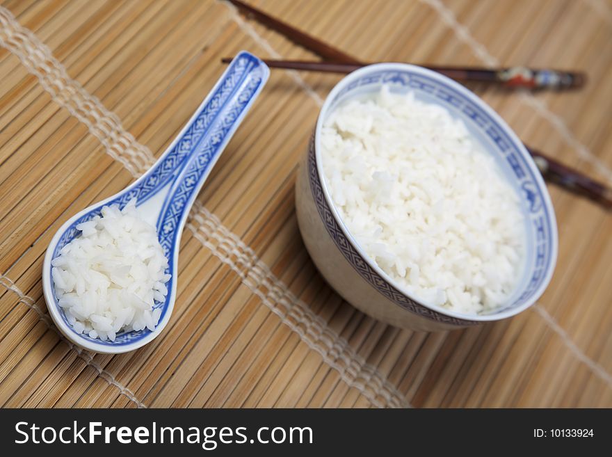 A bowl of perfectly cooked, plain Basmati rice, in an Asian style bowl, with a garnish of Thai Basil. A bowl of perfectly cooked, plain Basmati rice, in an Asian style bowl, with a garnish of Thai Basil