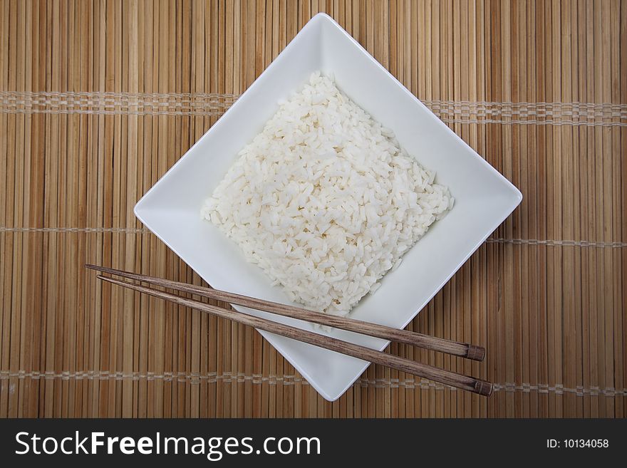 A bowl of perfectly cooked, plain Basmati rice, in an Asian style bowl, with a garnish of Thai Basil. A bowl of perfectly cooked, plain Basmati rice, in an Asian style bowl, with a garnish of Thai Basil