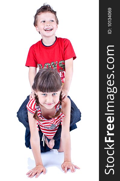 Cute blue-eyed children are playing and posing in studio