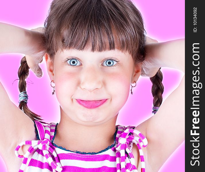 Cute little blue eyed girl making grimace, studio shot