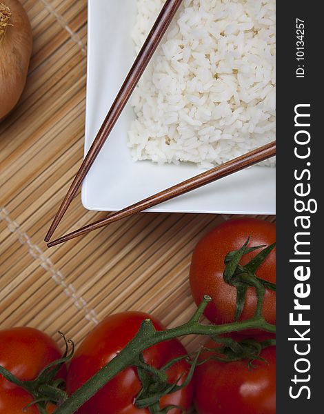 A bowl of perfectly cooked, plain Basmati rice, in an Asian style bowl, with a garnish of Thai Basil. A bowl of perfectly cooked, plain Basmati rice, in an Asian style bowl, with a garnish of Thai Basil