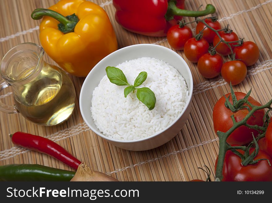 A bowl of perfectly cooked, plain Basmati rice, in an Asian style bowl, with a garnish of Thai Basil. A bowl of perfectly cooked, plain Basmati rice, in an Asian style bowl, with a garnish of Thai Basil