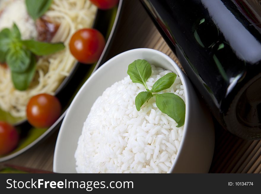 A bowl of perfectly cooked, plain Basmati rice, in an Asian style bowl, with a garnish of Thai Basil. A bowl of perfectly cooked, plain Basmati rice, in an Asian style bowl, with a garnish of Thai Basil