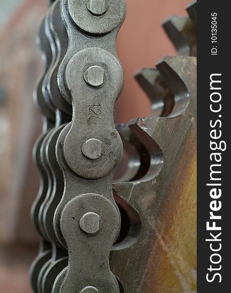 Close-up of heavy duty chain and cogwheel