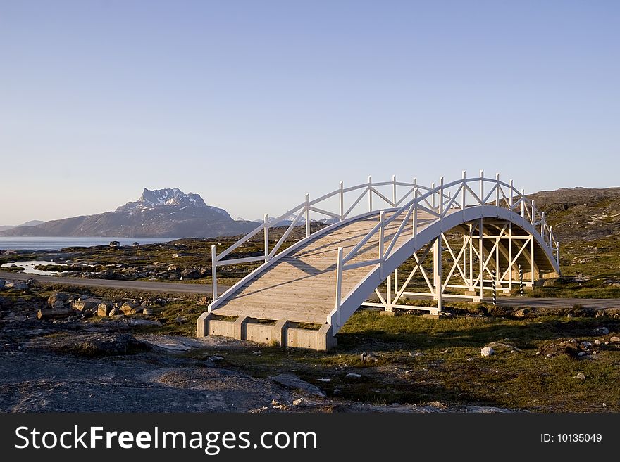 A bridge art piece in Nuuk, Greenland. Sermitsiaq, the mountain, is seen in the background. A bridge art piece in Nuuk, Greenland. Sermitsiaq, the mountain, is seen in the background.