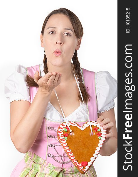 A woman dressed in traditional Bavarian costume in an Oktoberfest scenario blowing a kiss and a blank Herzl. A woman dressed in traditional Bavarian costume in an Oktoberfest scenario blowing a kiss and a blank Herzl.