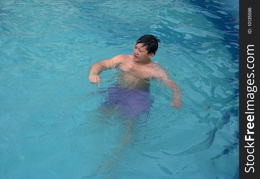 A young Tibetan floating happily in the pool. A young Tibetan floating happily in the pool.