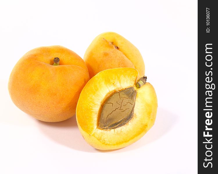 Few apricots on bright background with shadow. Is not isolated image