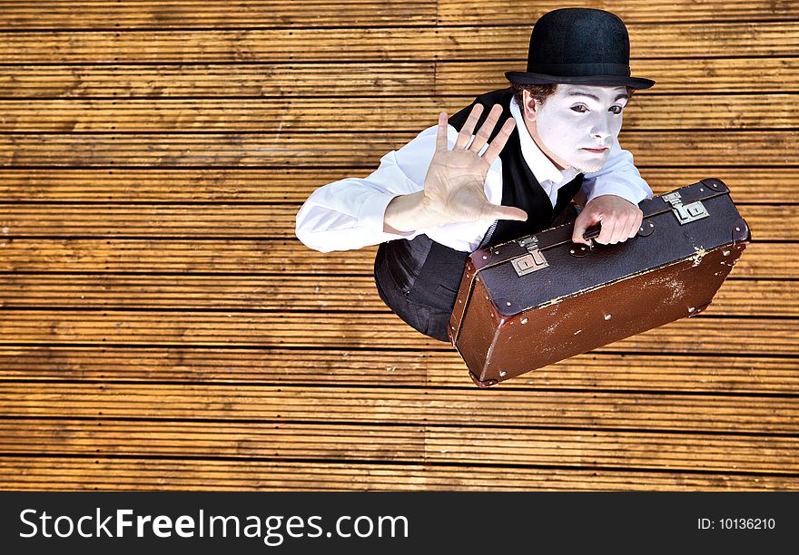 Portrait of the mime isolated on wood background