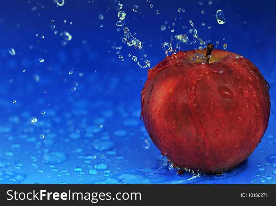 Red apple and water drops