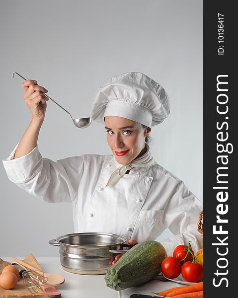 Female cook preparing a recipe. Female cook preparing a recipe