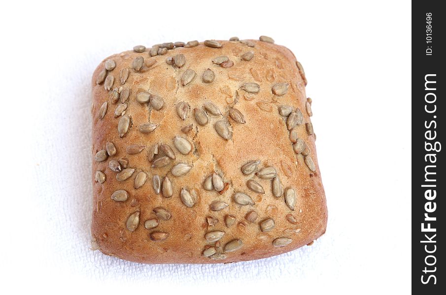 Roll with sunflower seeds isolated on a white background