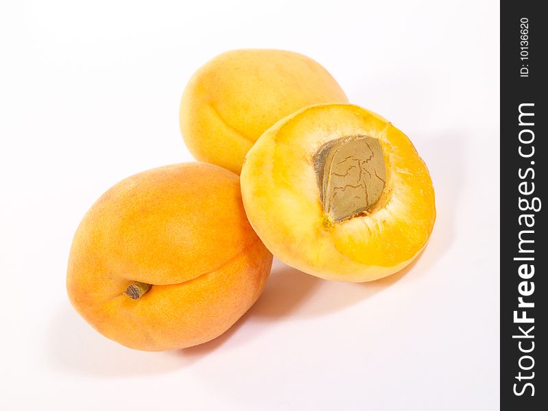 Few apricots on bright background