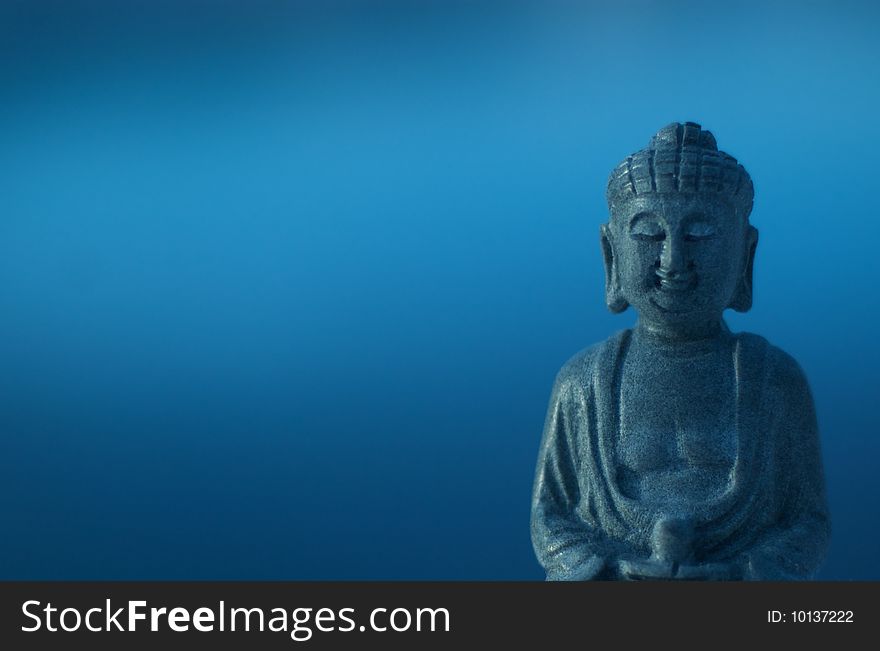 Buddha in right front of blue background. Buddha in right front of blue background