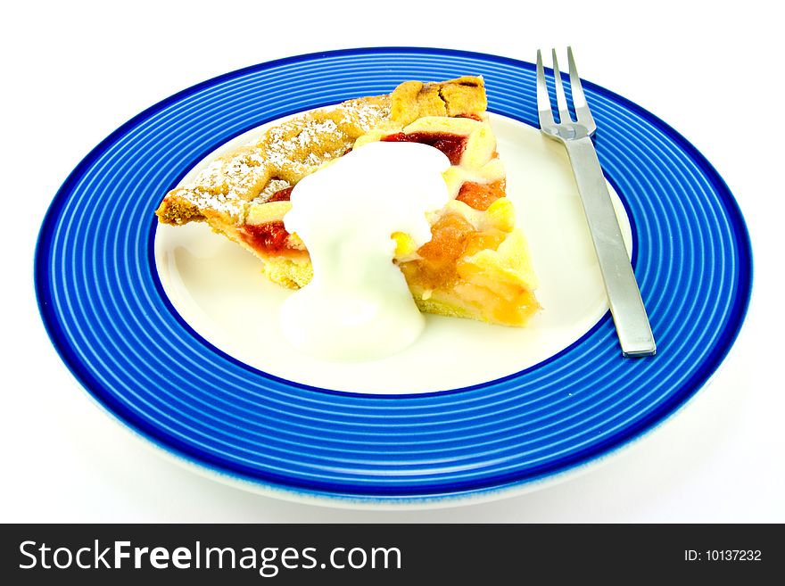 Slice of apple and strawberry pie with cream and a fork on a blue plate with a white background. Slice of apple and strawberry pie with cream and a fork on a blue plate with a white background