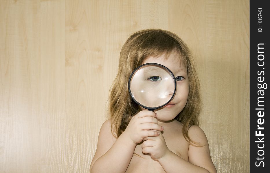 Little girl with big magnifier look for something. Little girl with big magnifier look for something