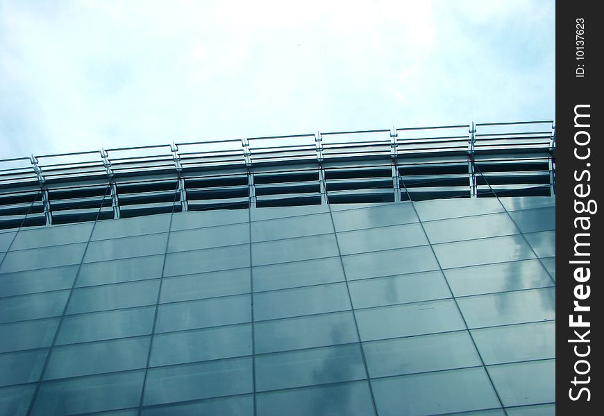 Top of glass building sky is reflected in which