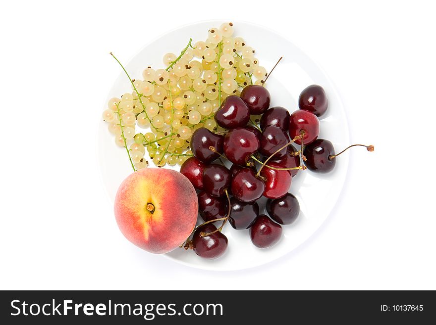 White currant, cherry and peach on white plate. White currant, cherry and peach on white plate