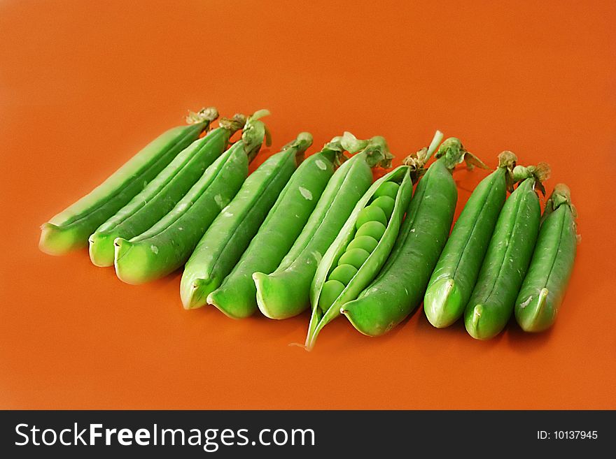Green peas Green peas vegetable with seed closeup view on orange background