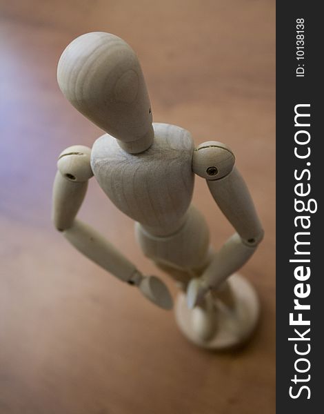 A little wooden statue with a human form