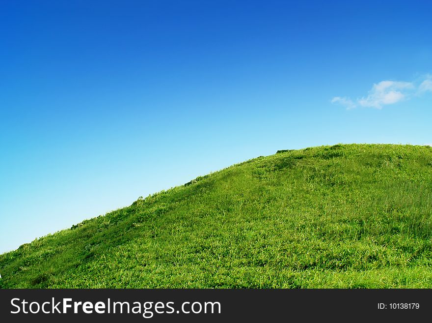 Green grass field under clear blue sky. Green grass field under clear blue sky