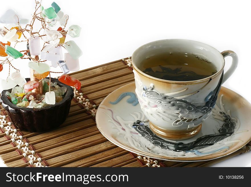 Cup of green tea and cash isolated tree on a white