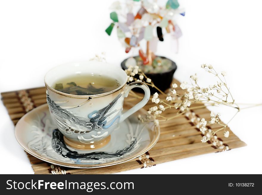 Cup of green tea and cash isolated tree on a white background