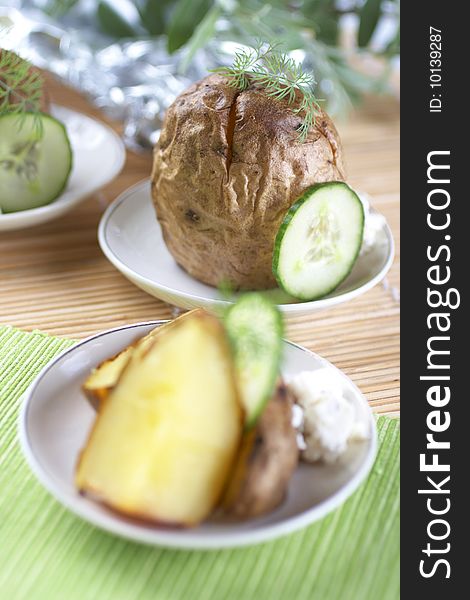 Baked potato with greens herbs