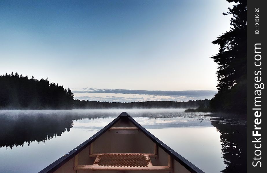 Canoeing across Pog Lake, Algonquin Provincial Park, in the misty morning. Canoeing across Pog Lake, Algonquin Provincial Park, in the misty morning.