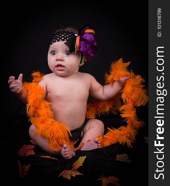 Baby In Fancy Dress With Feather Boa