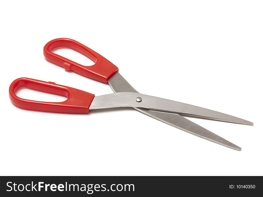 Red handled scissors isolated on a white background.