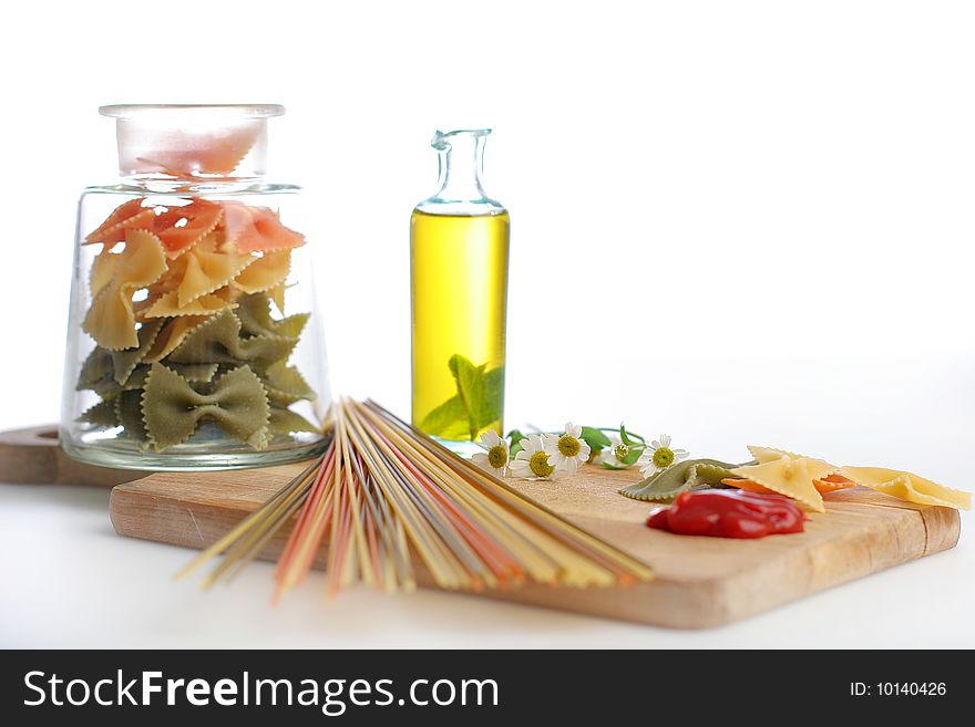 Pasta with oil bottle and ketchup.