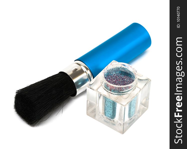 Blue make-up eyeshadows and cosmetic brush