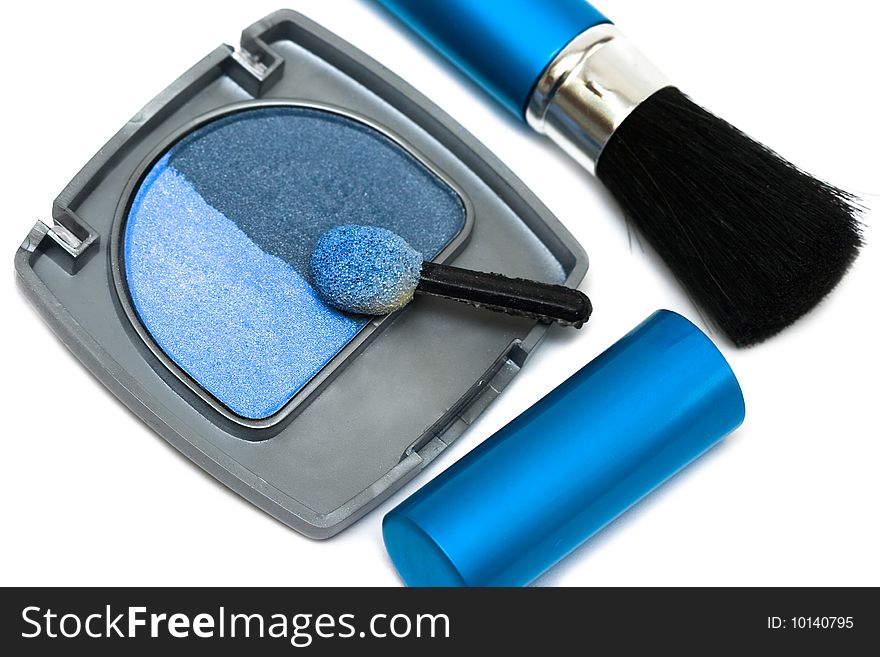 Blue make-up eyeshadows and cosmetic brush