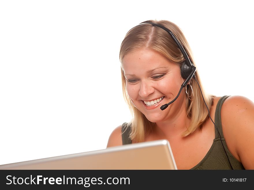 Attractive businesswoman smiles as she talks on her phone headset. Attractive businesswoman smiles as she talks on her phone headset.