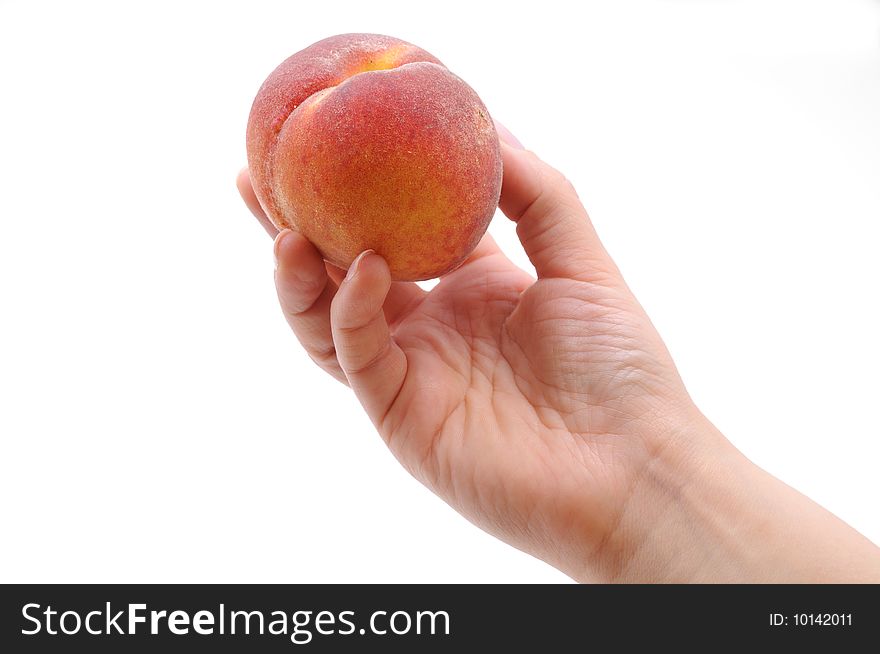 Hand taking a peach. Isolated on white background
