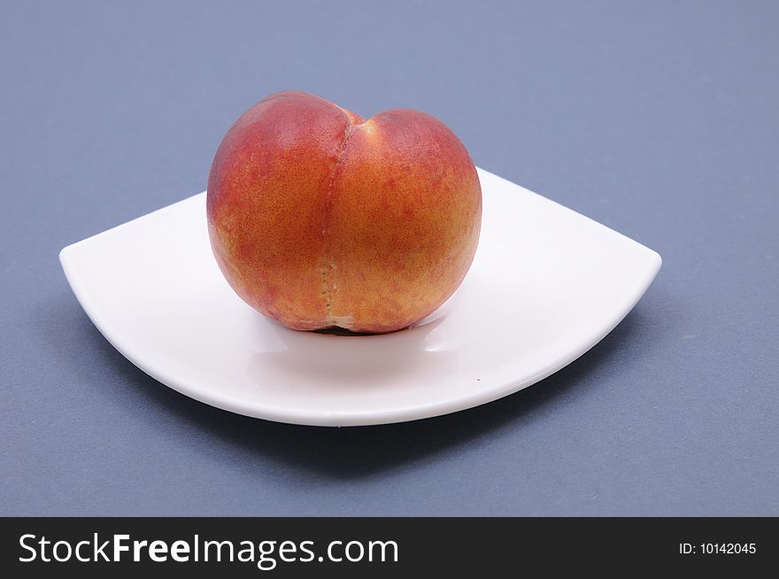 Fresh peach on white plate. Fresh peach on white plate.