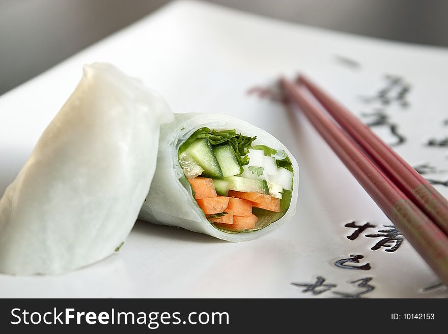 Springroll on a plate with chop sticks. Springroll on a plate with chop sticks