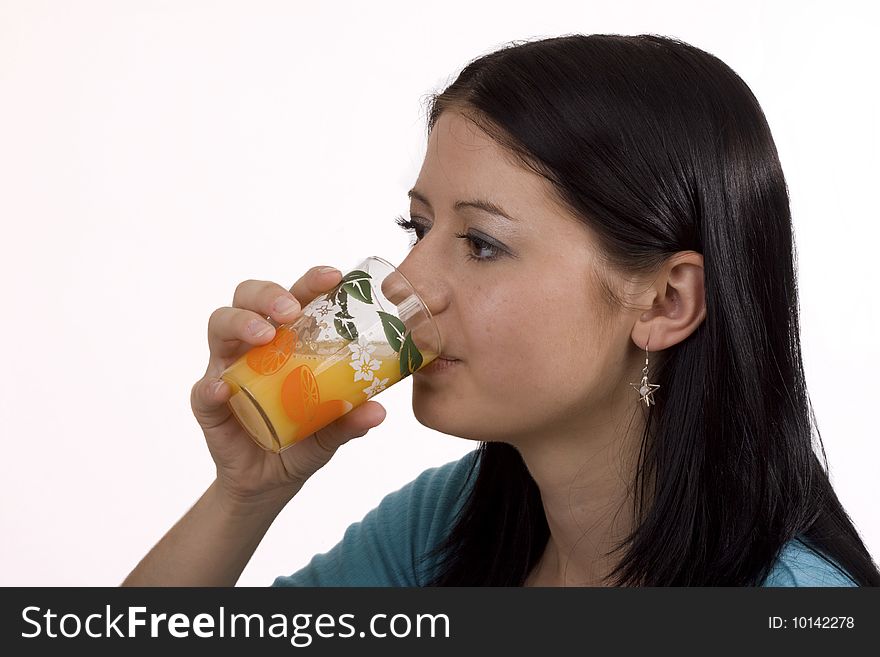 Young woman drinking glass of orange juice. Young woman drinking glass of orange juice