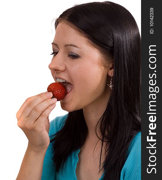 Young woman eating a red, ripe strawberry. Young woman eating a red, ripe strawberry