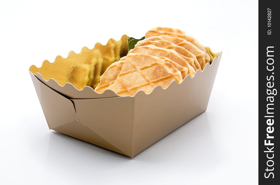 Dry biscuits in a golden box, the white background. Dry biscuits in a golden box, the white background