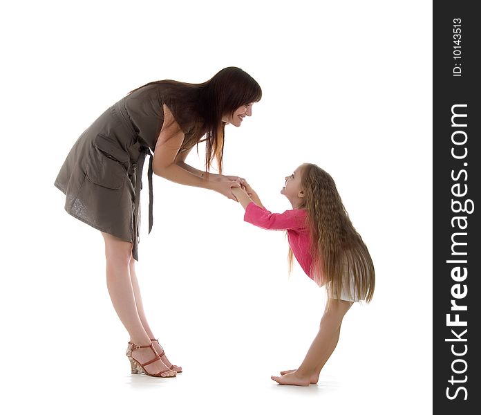 Cute little girl and her mother. Studio shot