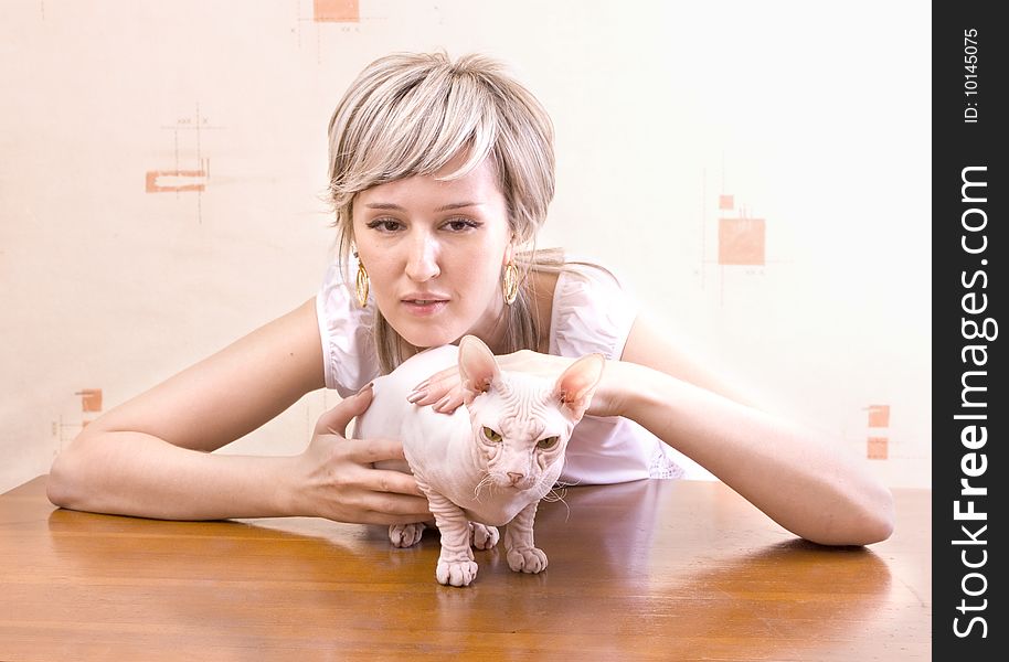 Woman dressed on white with sphinx cat. Woman dressed on white with sphinx cat