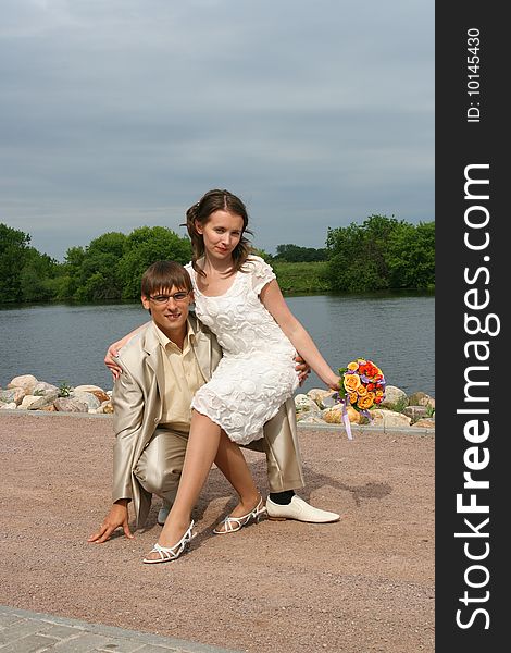 Newly-married couple on wedding walk in the cool afternoon