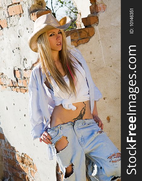 Beautiful girl wearing jeans and cowboy hat. Beautiful girl wearing jeans and cowboy hat