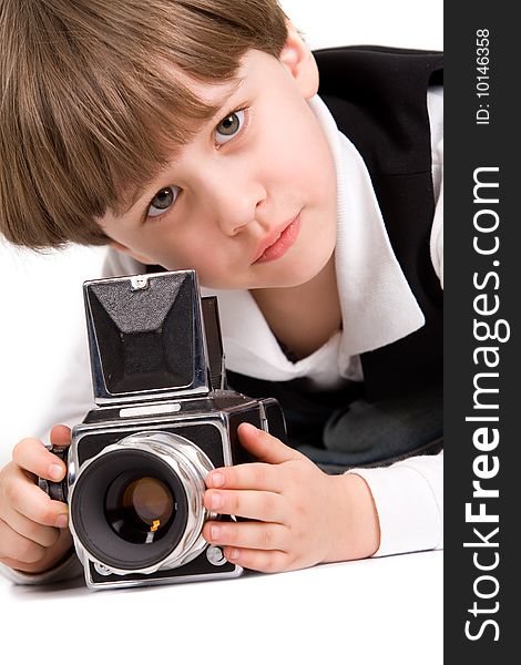 Attractive little boy with photo camera over white. Attractive little boy with photo camera over white
