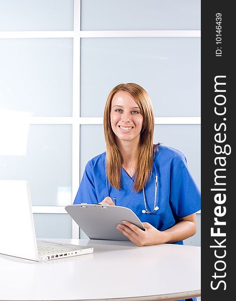 Female Nurse in a modern office holding a chart