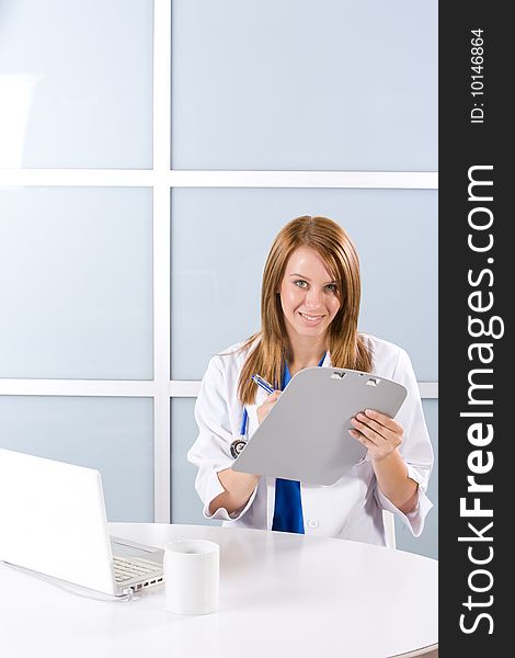 Woman doctor holding a chart in a modern office