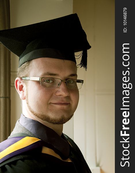 Portrait of handsome graduate indoors. Portrait of handsome graduate indoors