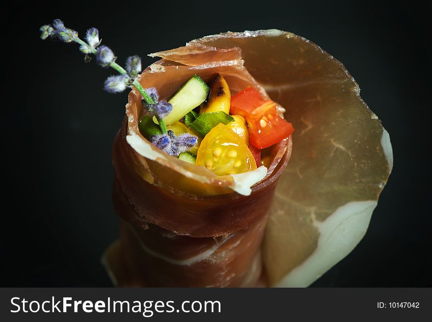 Appetizer with stuffed ham on dark background